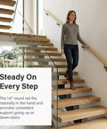 Woman using Oak 3-Foot Flush Handrail Kit For Indoor Stairs, 1.6-Inch Round Wood-Wrapped Aluminum Core Rail, modern design
