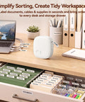 Gotta Love This Straight Up Compact Bluetooth Label Printer With Self Adhesive Tape Wireless Thermal Mini Label Maker on a desk organizing cables and files.
