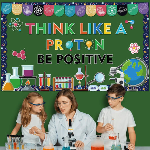 Three children in lab coats with science bulletin board reading 'Think Like a Proton' from 56Pcs Science Bulletin Board Decorations Set