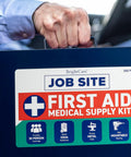 Front view of blue metal job-site first aid kit case held by hand, BrightCare label, 200-piece medical kit