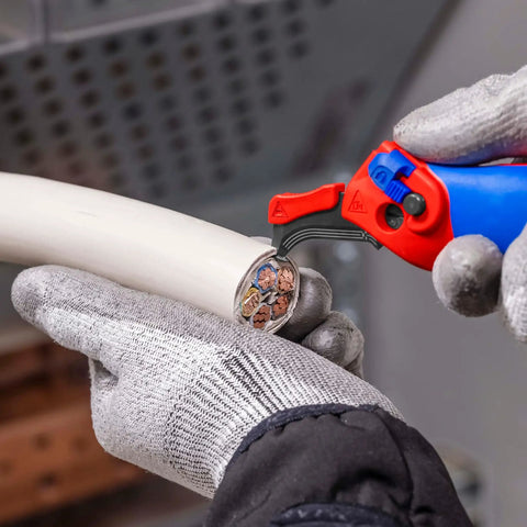 Person using stripping knife with sliding shoe and ratchet function for tough plastic sheaths up to 7 mm wall thickness