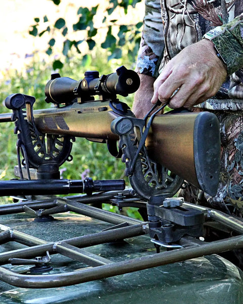 FlexGrip Pro Mounting Rack For Gun, Bow, Ice Augers And Tools, Universal ATV Fit in use securing a rifle on an ATV rack