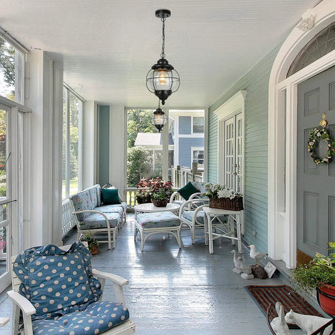 Outdoor Pendant Lights With Farmhouse Style Black Metal Hanging Porch Fixture And Clear Bubbled Glass Globe Inside An Iron Cage Frame For Rustic Vibe Exterior Lantern For Gazebo Patio And Entryway on a covered porch