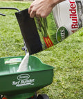 Person pouring Hassle Free Moss Control That Kills Moss And Thickens Grass, Fills Bare Spots, And Feeds To Prevent Future Moss