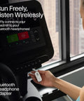 Person using Wireless Bluetooth Audio Transmitter For AirPods And Headphones With 20 Plus Hour Battery on treadmill display