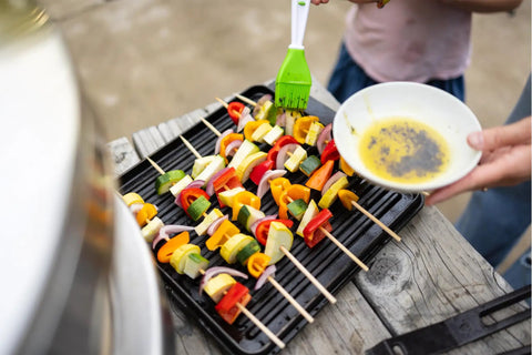Grilling vegetable skewers on Pi Cast Iron Three Piece Cookware Set With Round Skillet And Reversible Grill Griddle Removable Handles Bamboo Base