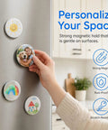 Hand placing custom 58mm fridge magnet from DIY kit on stainless steel refrigerator, featuring metal front and clear film.