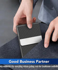 Person placing Slim Metal Business Card Holder with RFID Blocking PU Leather Case for Women or Men, Boss Vibe Black Carbon into pocket.