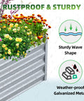 Raised Garden Bed 6x3x1 Foot Galvanized Metal Planter Box For Herbs Vegetables Flowers And Succulents In Silver Outdoor Tough Garden Bed With Ample Growing Space For Deep Rooted Plants And Porch Ready Design with flowers in rain showing sturdy wave shape and weather-proof galvanized metal.