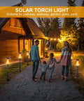Huge Solar Torch Light With Flickering Flame That Looks Lit Upgraded Ultra Bright Outdoor Solar Lights lining a garden path