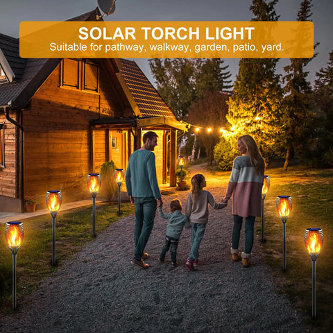 Huge Solar Torch Light With Flickering Flame That Looks Lit Upgraded Ultra Bright Outdoor Solar Lights lining a garden path