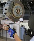 Heavy Duty Hand Vacuum Pump Brake Bleeder Kit With Gearless Diaphragm Gauge And Dead Simple One Finger Release being used on brake caliper.