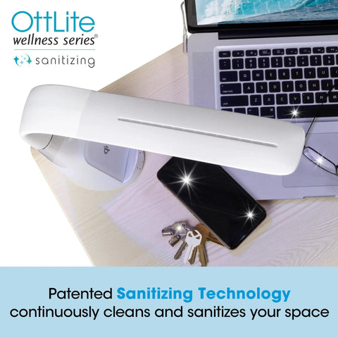 Purify LED Desk Lamp With Wireless Charging, Touch Activated, Flexible Gooseneck illuminating a desk with phone and keys