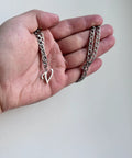 Hand holding Unisex A-Z Initial Necklace In Stainless Steel, Cuban Link Chain, 21 Inch Length, Durable Letter Pendant For Men And Women