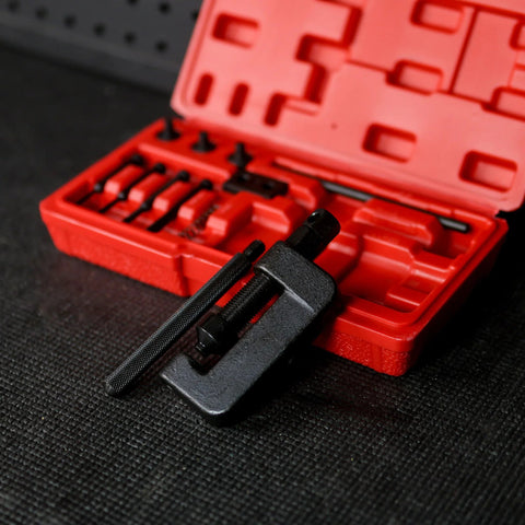 Front view of red 13-piece chain breaker tool kit in open case with black clamp-style breaker in foreground