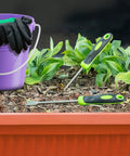 Purple bucket and gloves beside two Stand Up Weed Puller Tool With Long Handle For Lawn And Garden on soil.