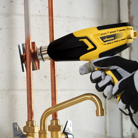 FURNO 700 Digital Heat Gun with 2 Nozzles used for soldering copper pipes, showcasing temperature control and ergonomic design.