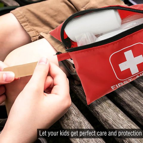 Small 166 Piece Emergency First Aid Kit for Outdoors Camping Auto Home and Workplace with open pouch on wooden bench
