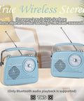 Two Grab N Go Portable AM FM Shortwave Radio Bluetooth Speakers with TWS, displayed on a wooden table indoors.