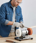 Person using the Heavy Hitter 96W Mini Belt Sander With Seven Adjustable Speeds And Brushless Motor for knife sharpening.