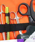 Front view of orange Lightning X EMS trauma bag with silver tools and a lime-green penlight in a black elastic strap.