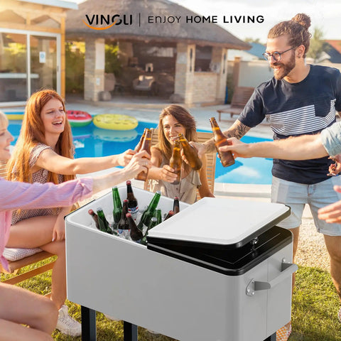 80 Quart Rolling Ice Chest On Wheels With Bottle Opener next to people enjoying drinks at a poolside party