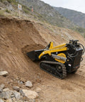 Track Type Mini Skid Steer Loader Workhorse For Construction And Landscaping Jobs operating on rocky terrain, front view.