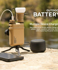 Nestout Rugged 15000mAh Power Bank for Outdoors connected to devices on rock surface