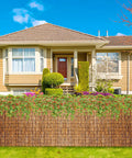 Privacy Bamboo Fence Roll For Outdoor Spaces Coffee Color 2.6x6.6ft in front of a house with garden
