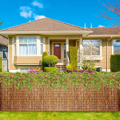 Privacy Bamboo Fence Roll For Outdoor Spaces Coffee Color 2.6x6.6ft in front of a house with garden