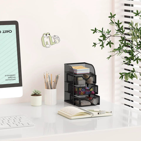 Mesh Desk Organizer With Three Drawers For Office And Home A Must Have Stationery Caddy For Paper Clips Post It Notes Staples And Small Accessories Clear Mesh Storage Keeps Essentials Visible Ideal For Students Black on a white desk in an office setup with plants in the background