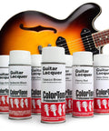Get That Fresh Retro Vibe With This Badass Tobacco Sunburst Aerosol Finishing Set For Later Kalamazoo Electric Guitars Complete Eight Can DIY Refinish Kit For Slick Pro Results - Eight aerosol cans lined up with a tobacco sunburst guitar.