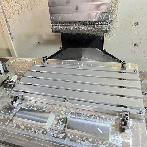 Badass Straight Up Heavy Duty 6061 Anodized Aluminum T Slot Plate Fixturing Table For CNC Milling with parts mounted.