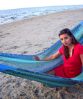 Woman relaxing on Jumbo Mayan Mexican Hammock For Big Groups And Families on a beach, showcasing large hammock for two or more people.