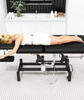 Black Electric Spine Massage Table With Dual Motors And Hydraulic Lift Adjustable Waist Support For Physical Therapy Facial Spa Waxing And Tattoo Clinics Versatile Treatment Bed with client lying face down