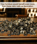 Top Shelf Brass Upholstery Tacks For Furniture Restoration, 200 Piece Box Of Classic Vintage Decorative Nail Pins in a pile on a table.