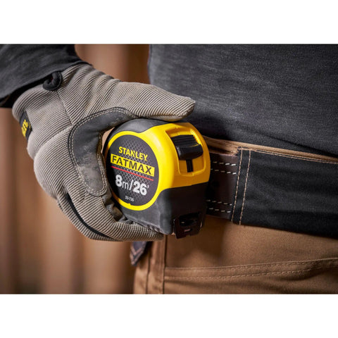 Worker holstering Fatmax Tape Measure With Blade Armor And Dual Scale 8m Length, Mylar Coated Blade Delivers 10x Abrasion Resistance