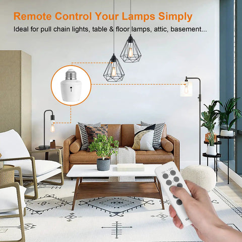 Living room with a hand holding a remote for Remote Control Light Socket Set With Five E26 E27 Bases, showing lamps and wall decor.