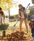 Adult using 68 Inch Metal Rake With Adjustable Handle Built For Heavy Duty Leaf Cleanup And Thatch Removal in a garden setting