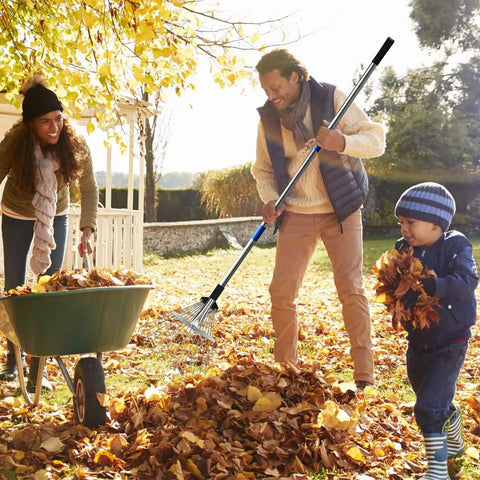 Adult using 68 Inch Metal Rake With Adjustable Handle Built For Heavy Duty Leaf Cleanup And Thatch Removal in a garden setting