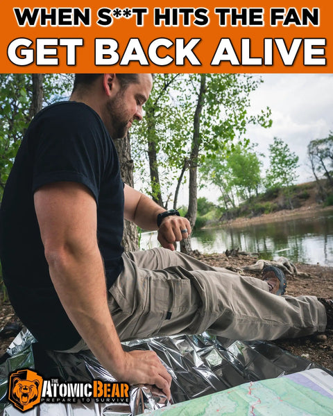 Person sitting by a lake with survival gear, wearing a Paracord Survival Bracelet 2 Pack With Fire Starter Ferro Rod Loud Whistle Compass.