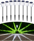 Solar Pathway Lights 10 Pack Outdoor Waterproof LED Stainless Steel Stakes illuminating lawn with cold white light.