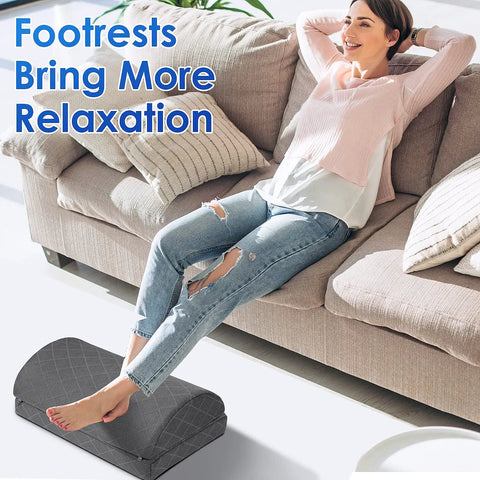 Person relaxing on a couch with Under Desk Foot Rest For Work And Gaming With Non Slip Bottom Two Adjustable Heights And Removable Cover