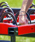 Man installing Heavy Duty 9 Inch Hay Grapple Replacement Hook Pack For Hay Accumulator onto red farm equipment frame