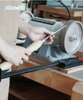 Total No Sweat Setup For Your Shop This Upgraded Grinding Jig System Cranks Out Razor Sharp Edges On Wood Chisels Turning Tools And Bowl Gouges Using Standard Eight Inch Grinders, showing precise sharpening on a grinding wheel.
