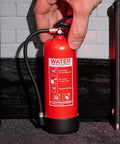 Rad Miniature Resin Fire Extinguisher 1/4 Scale Replica shown being held, featuring printed safety instructions.