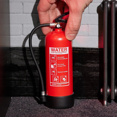 Rad Miniature Resin Fire Extinguisher 1/4 Scale Replica shown being held, featuring printed safety instructions.