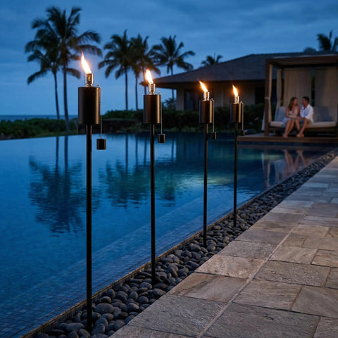 55 Inch Outdoor Oil Torch Lamps Four Pack Rustproof Stainless Steel Citronella Torches by a pool in a backyard setting at night