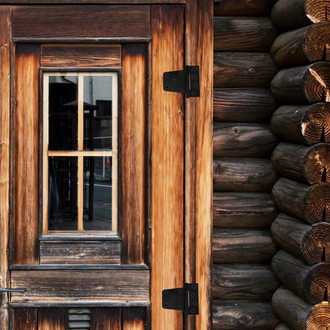 Built Tough 3.5 Inch Weld On Gate Hinges Black Heavy Duty for barn door installation shown on wooden log cabin