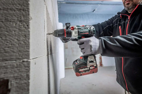 Premium 18V Brushless Cordless Hammer Drill Driver Featuring A Beefy Half Inch Quick Swap Chuck And Smart Torque Control To Rattle Off Stripped Bolts Like A Boss While Crushing Concrete Tasks Tool Only drilling into a concrete wall.